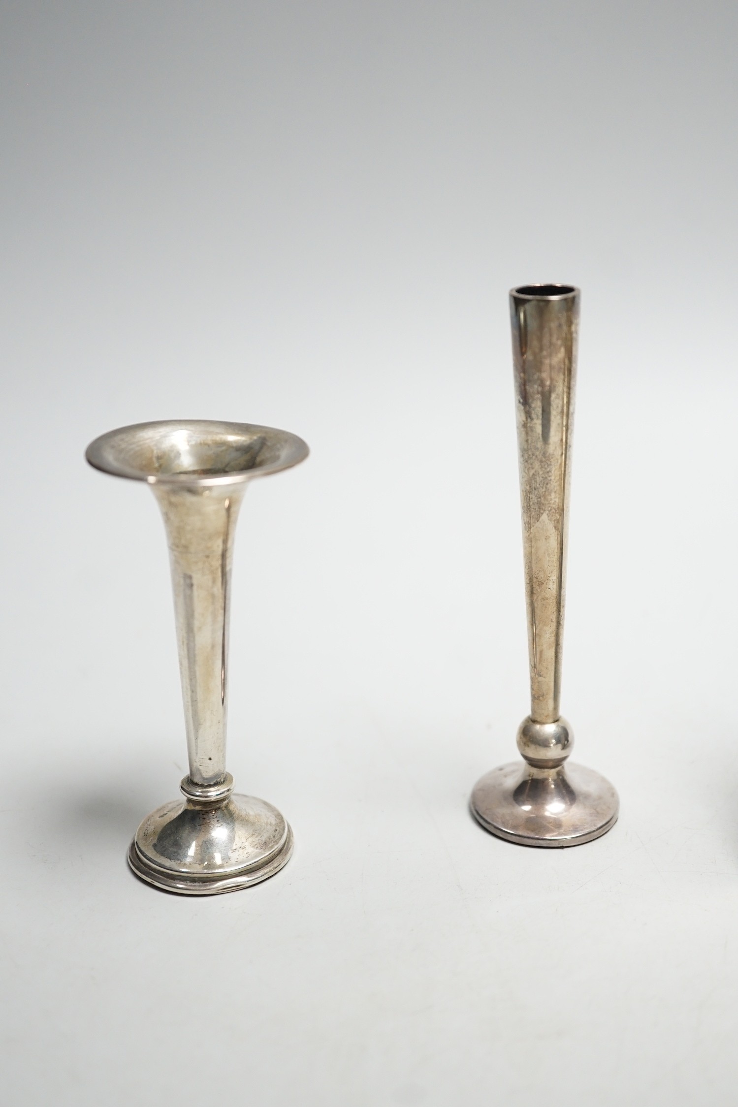 A white metal mounted desk calendar, with inset flag and two small silver mounted vases.